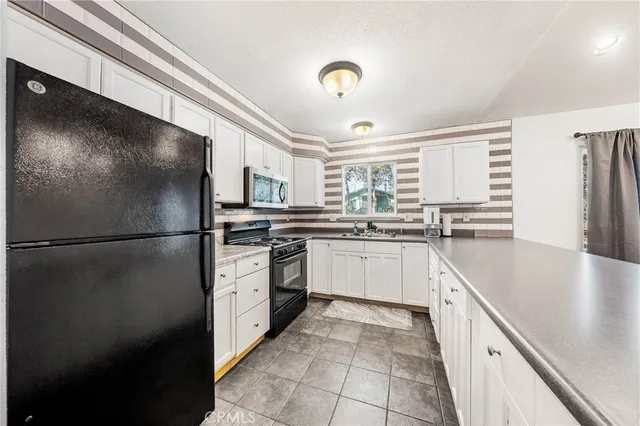 a kitchen with a refrigerator and a sink