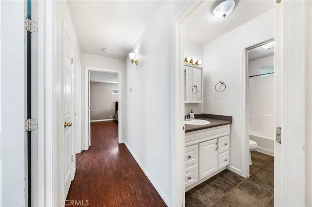 a spacious bathroom with a granite countertop sink mirror and toilet