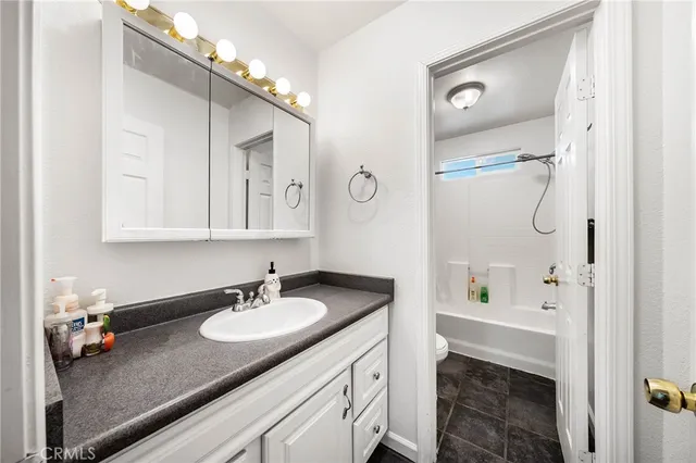 a bathroom with a sink double vanity granite tub and shower