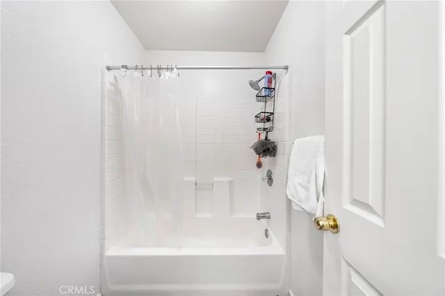 a bathroom with a shower curtain and a bathtub