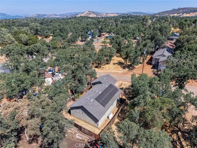 an aerial view of a house with a yard