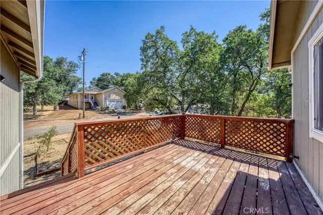a view of balcony with wooden floor and fence