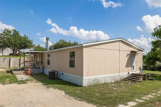 a backyard of a house with table and chairs