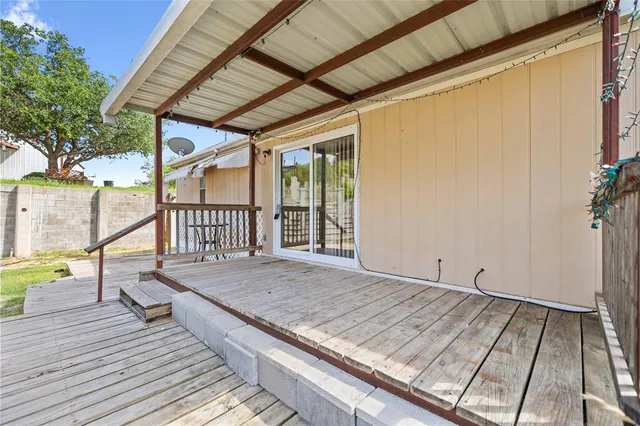 a view of a balcony with wooden floor