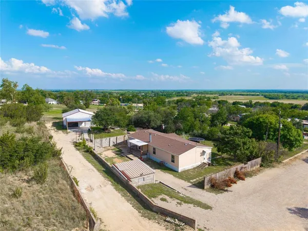 an aerial view of a house with a garden and trees