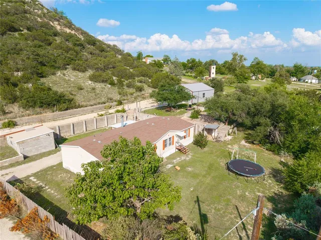 a view of a swimming pool with a patio and mountain view