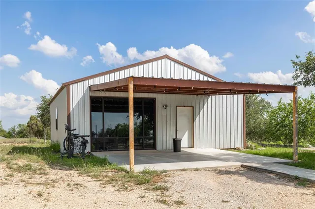 a view of a house with backyard porch and sitting area