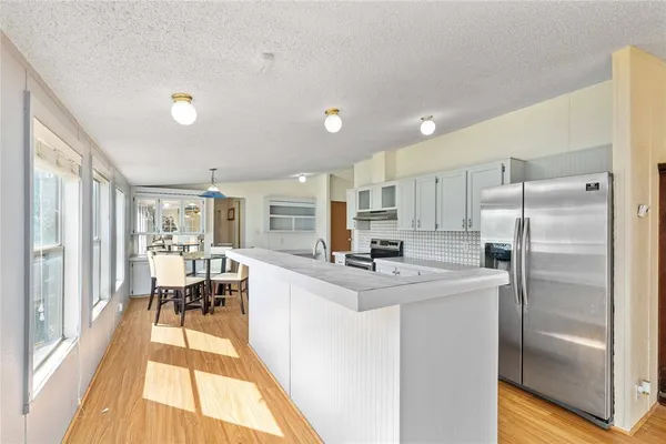 a kitchen with granite countertop a sink stainless steel appliances and cabinets
