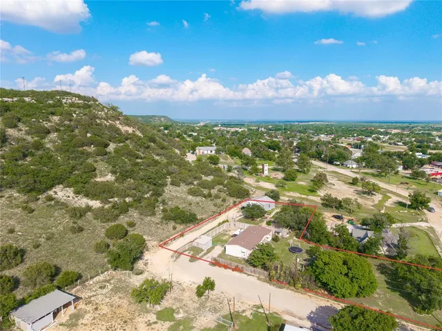 an aerial view of a house with a garden and lake view