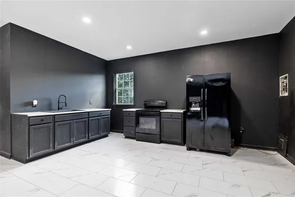 a kitchen with stainless steel appliances a sink stove and cabinets