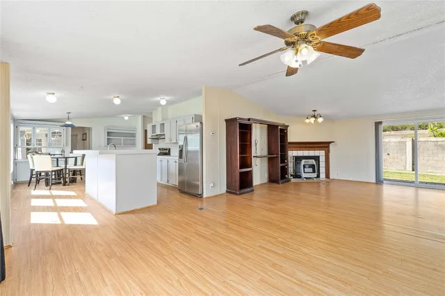 a view of a livingroom with a furniture wooden floor and a kitchen