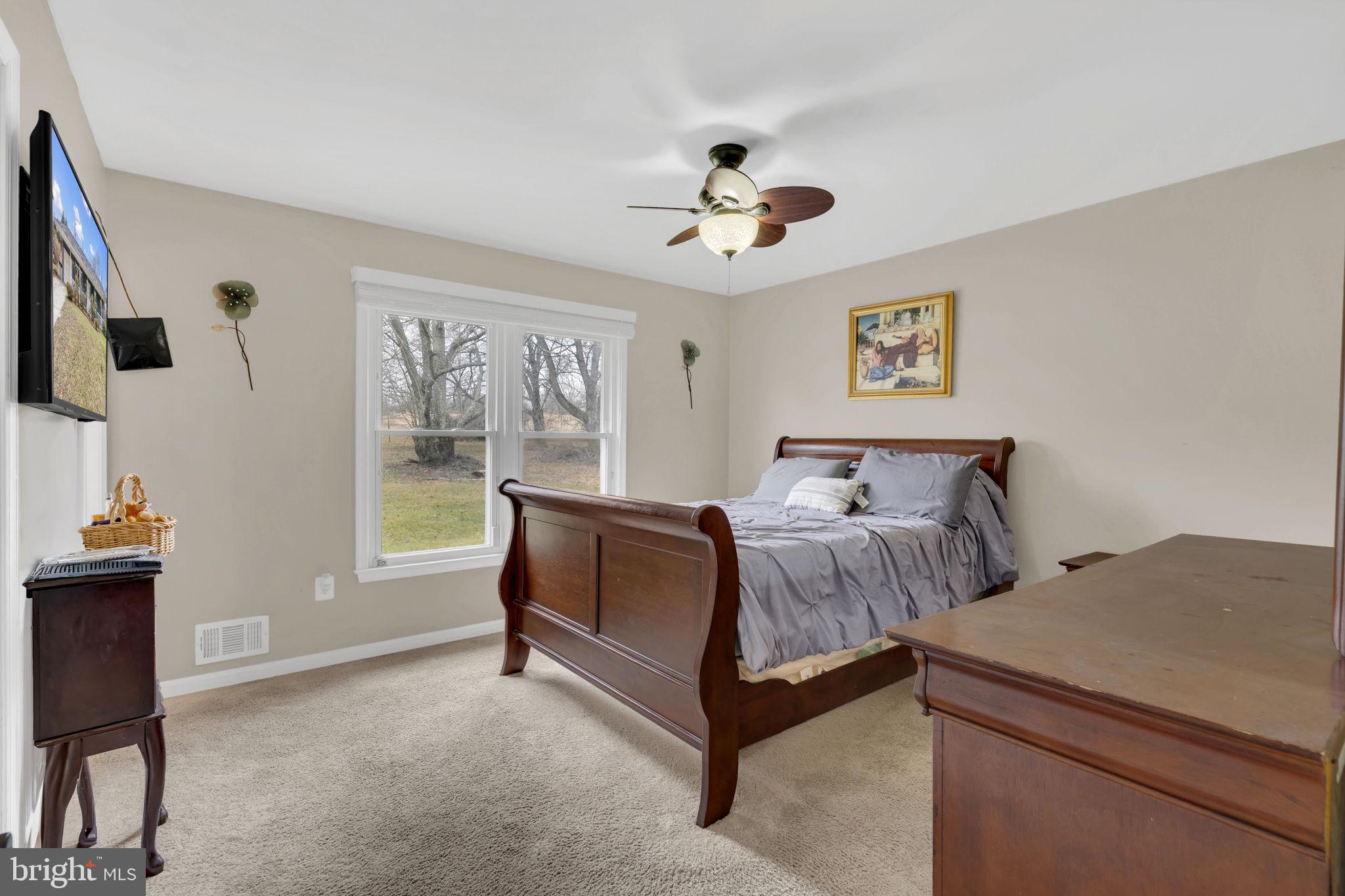 9104 Trumps Hill Road Upper Marlboro, MD 20772 - Photo 20 of 25 a bedroom with a bed and a chandelier
