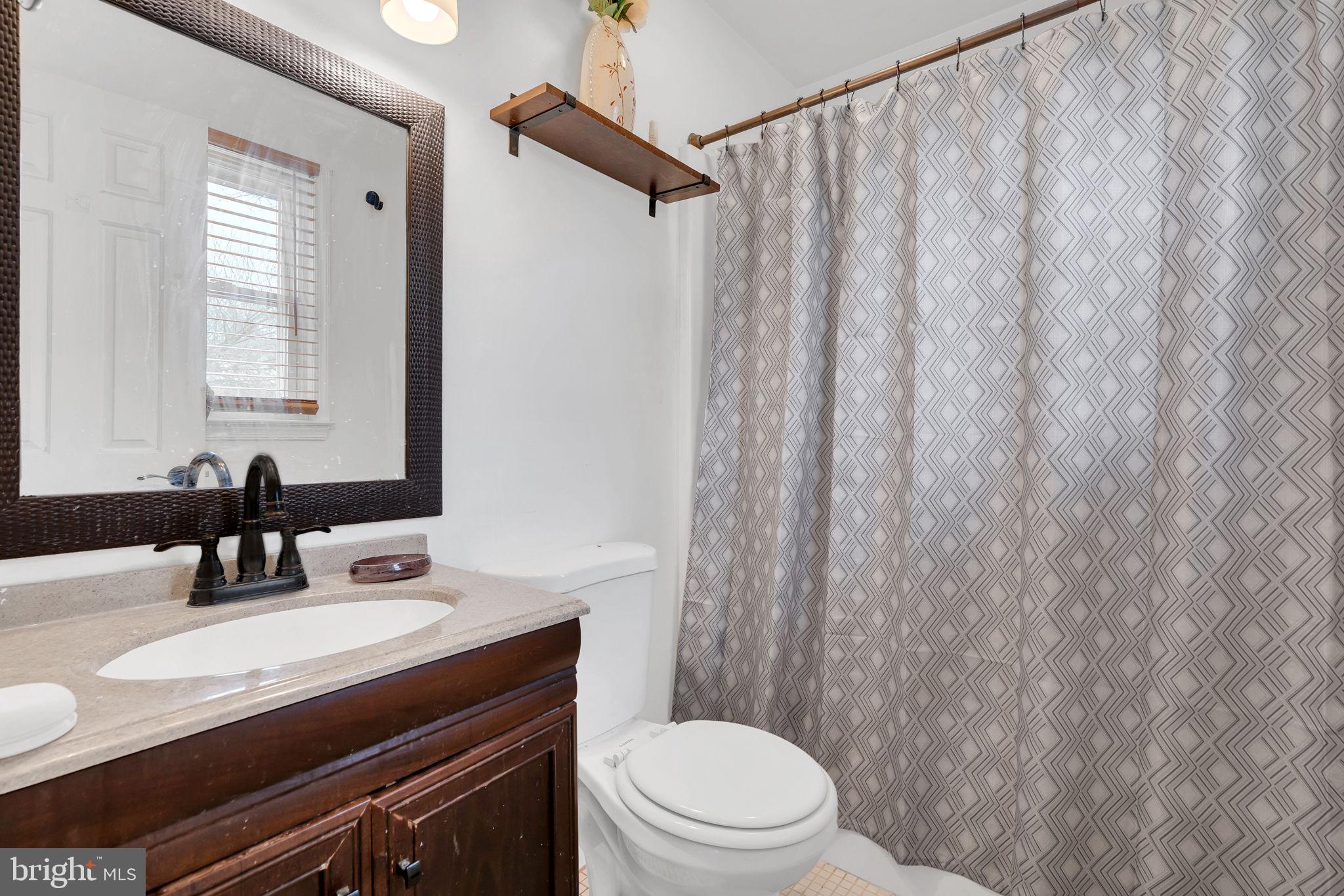 9104 Trumps Hill Road Upper Marlboro, MD 20772 - Photo 21 of 25 a bathroom with a sink toilet and shower