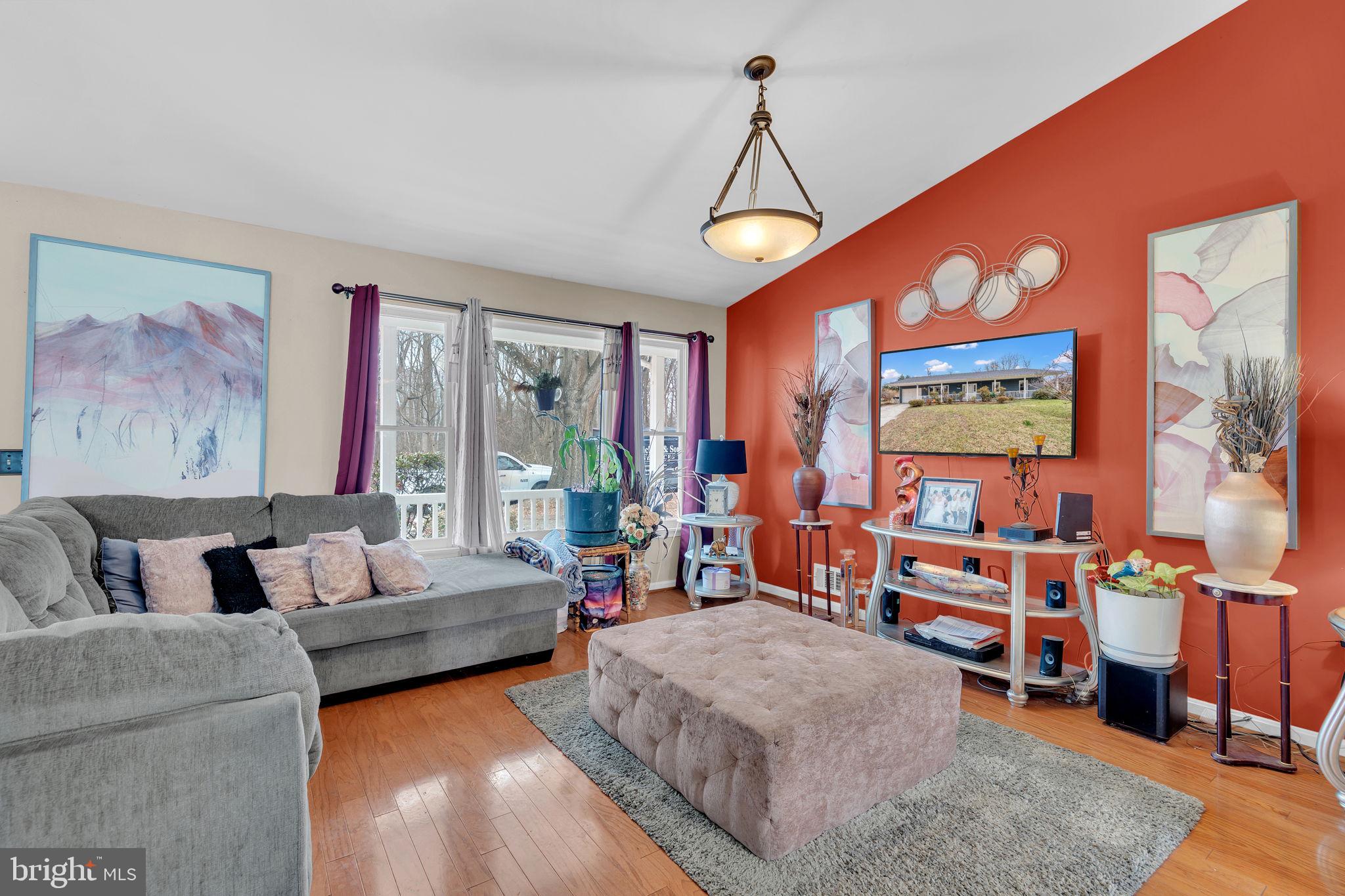 9104 Trumps Hill Road Upper Marlboro, MD 20772 - Photo 4 of 25 a living room with furniture a flat screen tv and a large window
