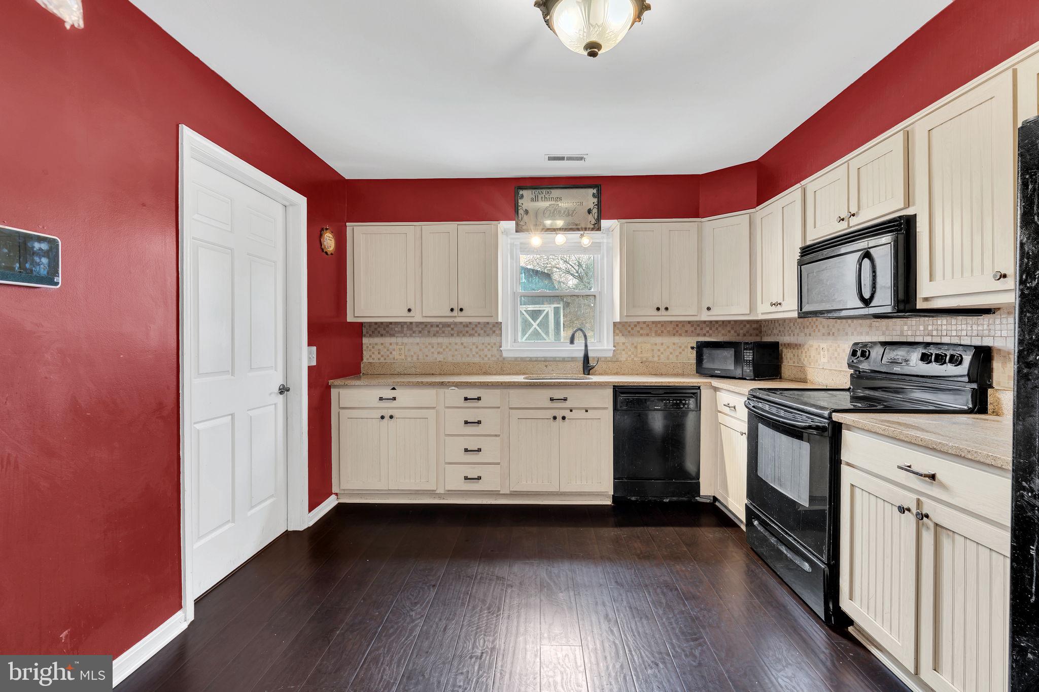 9104 Trumps Hill Road Upper Marlboro, MD 20772 - Photo 8 of 25 a kitchen with stainless steel appliances granite countertop a stove a sink and a microwave