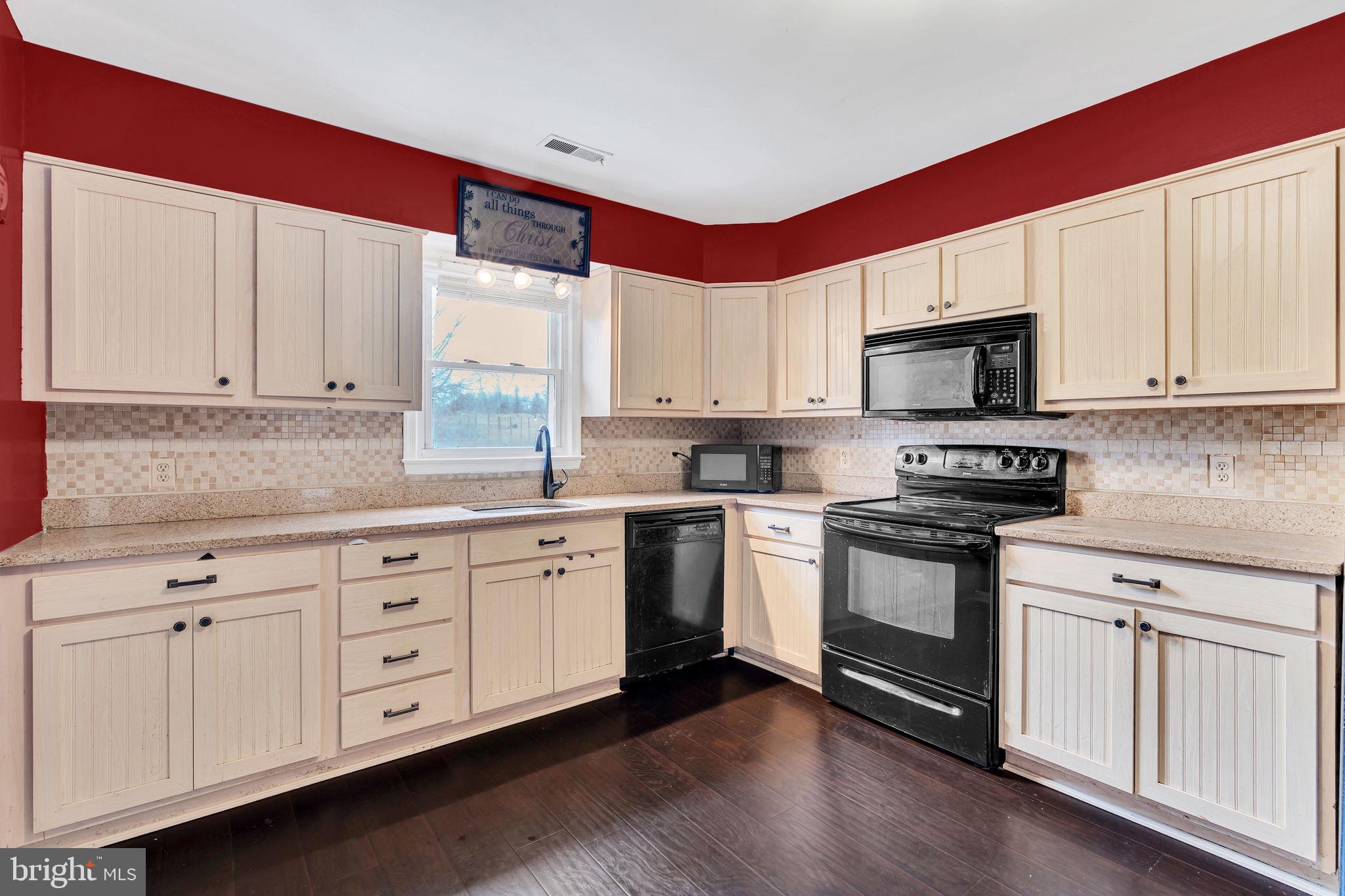 9104 Trumps Hill Road Upper Marlboro, MD 20772 - Photo 9 of 25 a kitchen with granite countertop white cabinets stainless steel appliances and a window