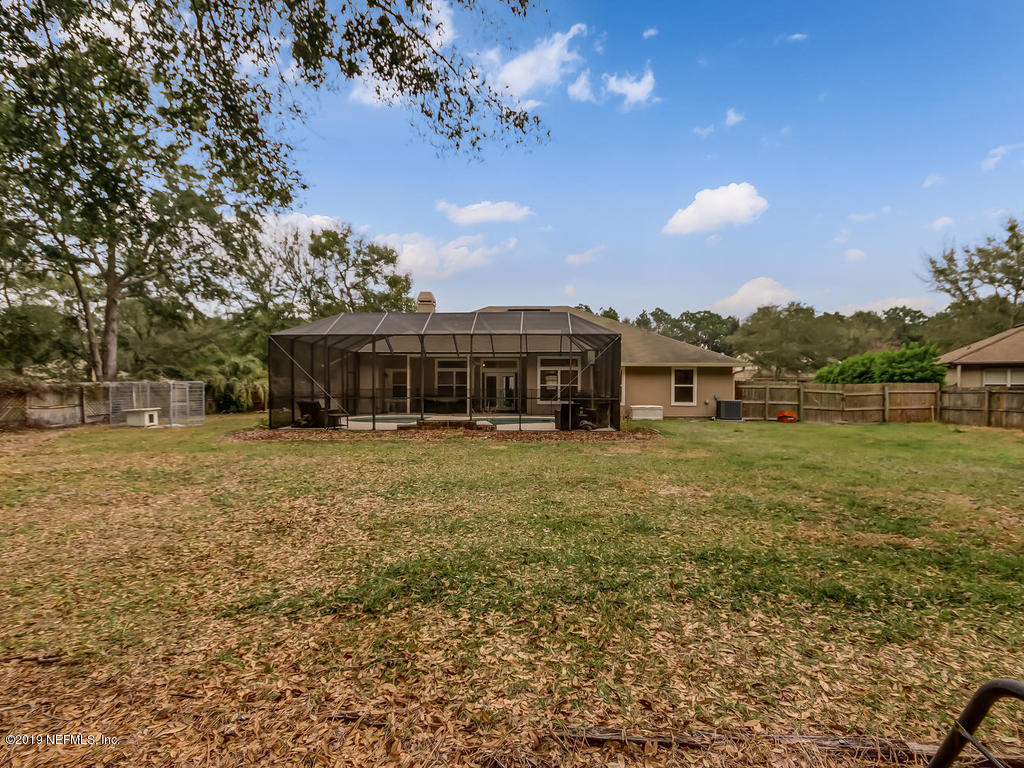 97064 Castle Ridge Drive Yulee, FL 32097 - Photo 54 of 60 a view of a house with a big yard