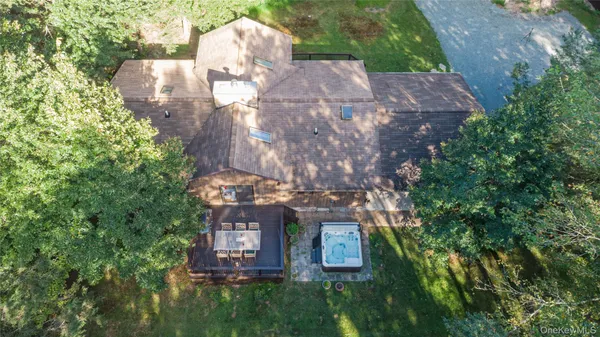 a aerial view of a house with a yard and large trees