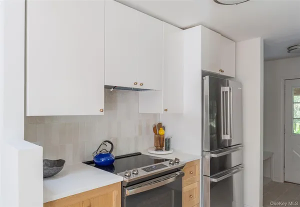a kitchen with a stove and a refrigerator