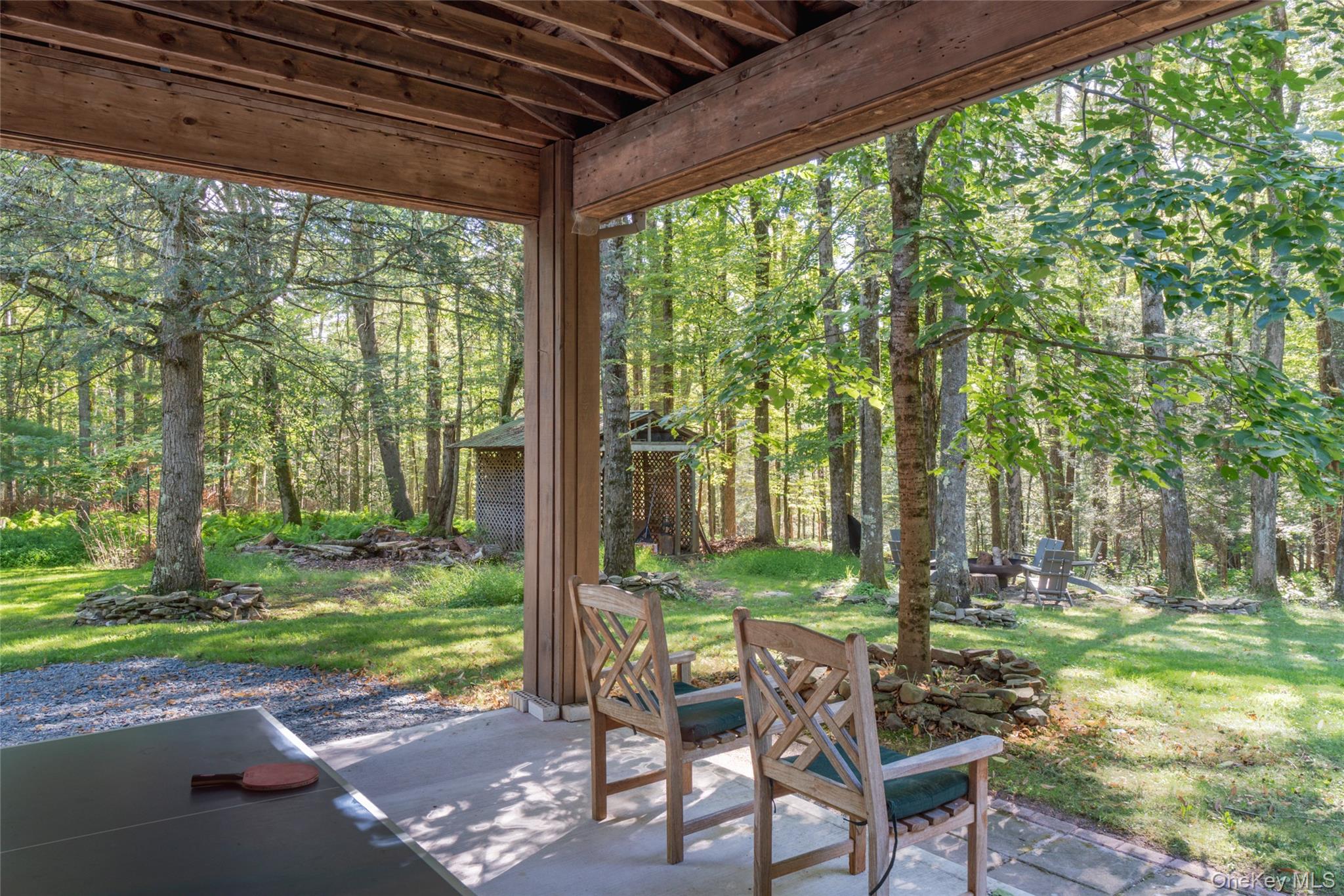 15 Deer Meadow Road Bethel, NY 12786 - Photo 30 of 40 a view of backyard with table and chairs and floor to ceiling window with yard