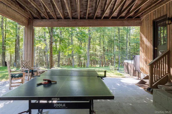a room with pool table and windows