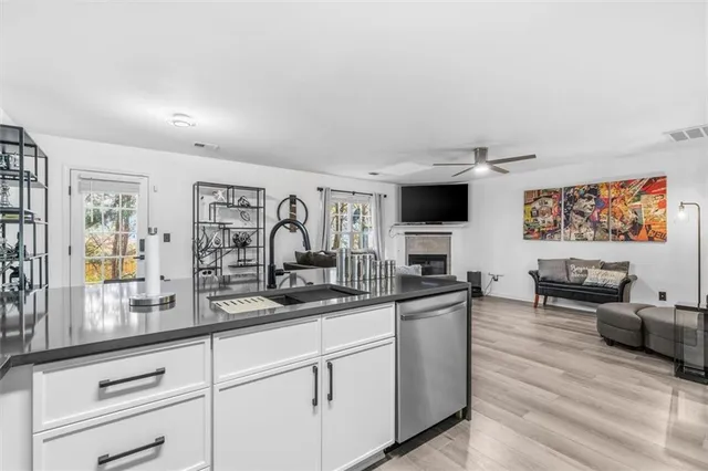 a kitchen with stainless steel appliances granite countertop a stove and cabinets