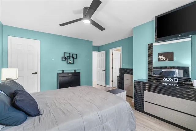 a bedroom with a bed and a flat screen tv