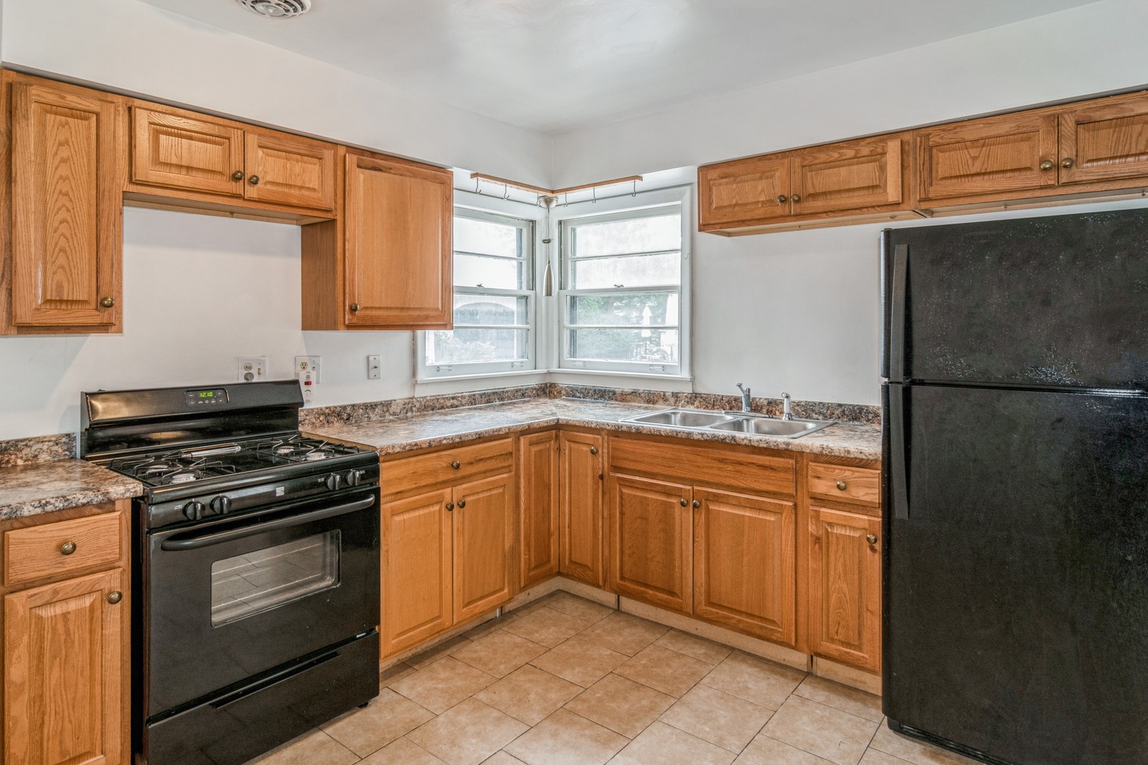 609 North County Line Road Hinsdale, IL 60521 - Photo 5 of 12 a kitchen with granite countertop cabinets stainless steel appliances and a window