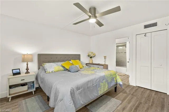 a living room with kitchen island granite countertop wooden floor and a fireplace
