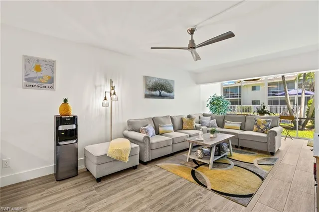 a kitchen with a refrigerator a stove top oven a sink dishwasher and white cabinets with wooden floor