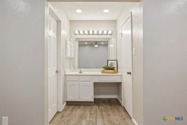 a bathroom with a sink a mirror and a bathtub