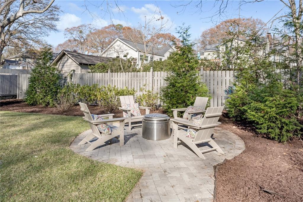 777 Forrest Street Northwest Atlanta, GA 30318 - Photo 31 of 35 a view of a patio with table and chairs potted plants and a large tree