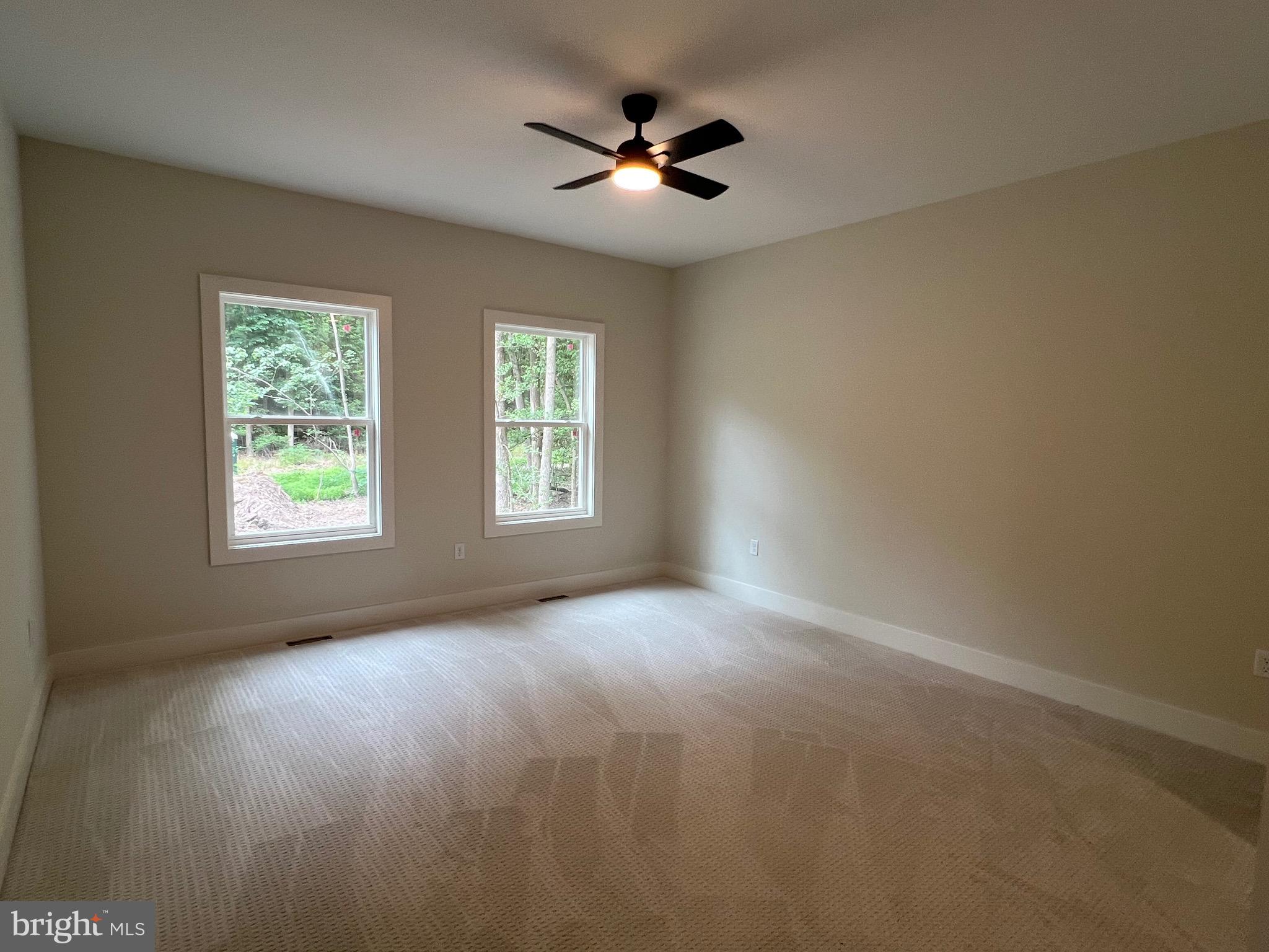 175 Rose Way Colonial Beach, VA 22443 - Photo 15 of 33 an empty room with windows and ceiling fan