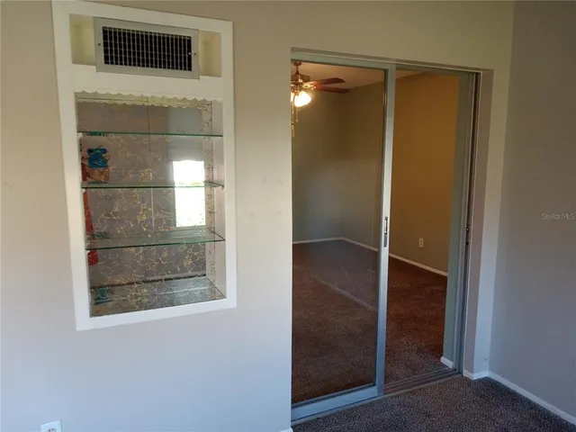 a bathroom with a shower and closet