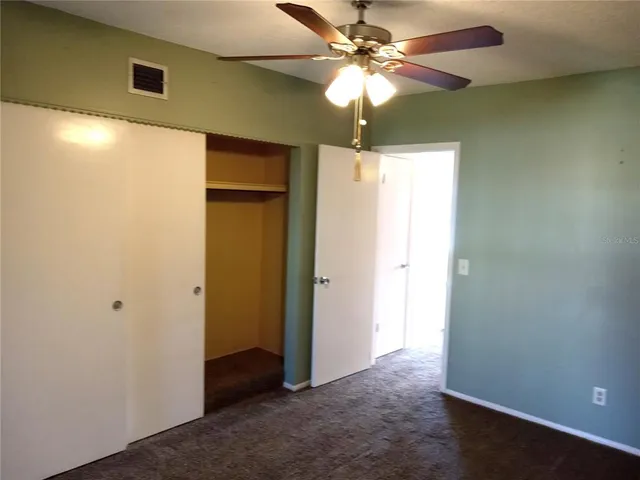 a view of a livingroom with a chandelier fan