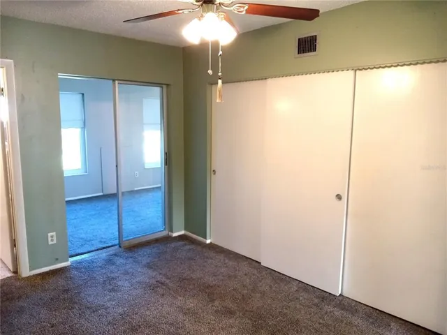 an empty room with windows and closet