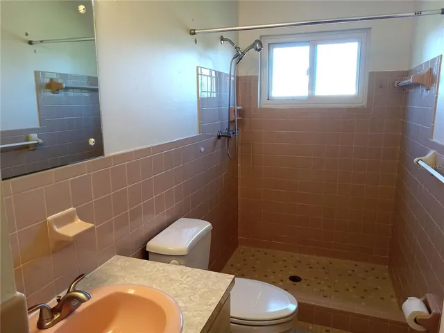 a bathroom with a toilet and shower