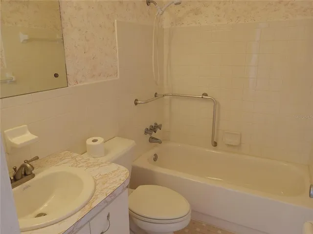 a bathroom with a sink toilet and bathtub