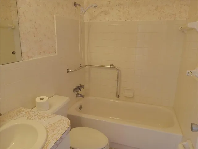 a bathroom with a sink toilet and bathtub