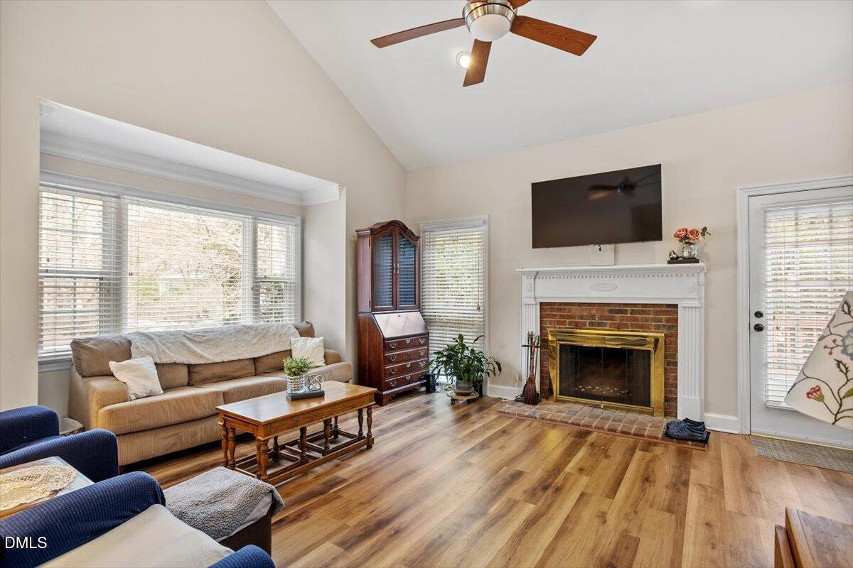 126 Skylark Way Raleigh, NC 27615 - Photo 6 of 25 Bright and airy living room with cathedral ceiling and fireplace