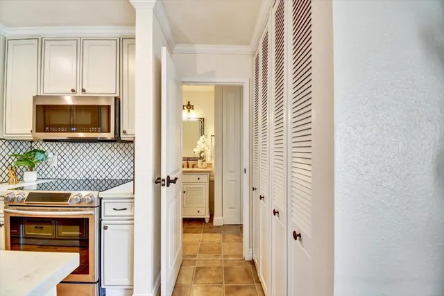 a kitchen with cabinets and a stove top oven