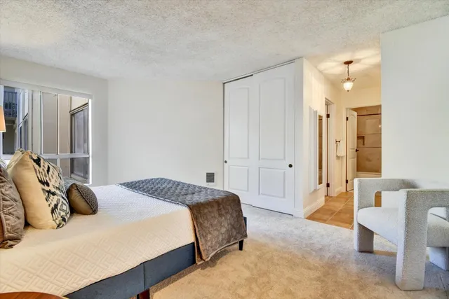 a spacious bedroom with a bed and a couch