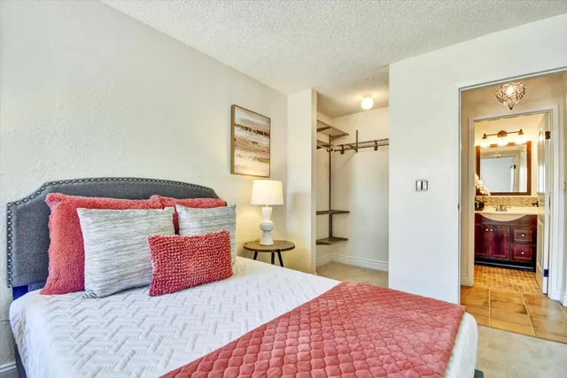 a bedroom with a large bed and a bathroom