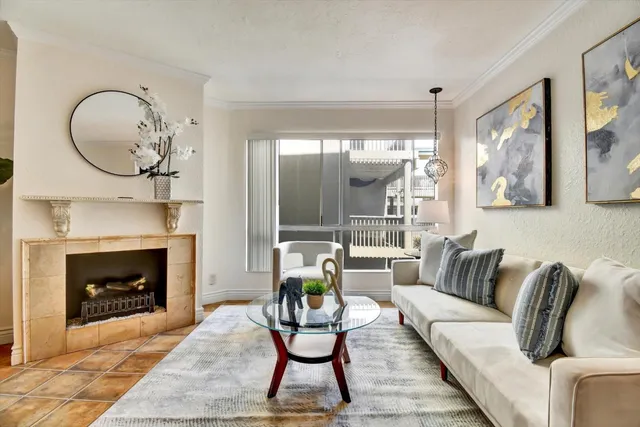a living room with furniture a fireplace and window