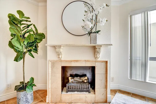 a vase with flowers on a table in front of a window