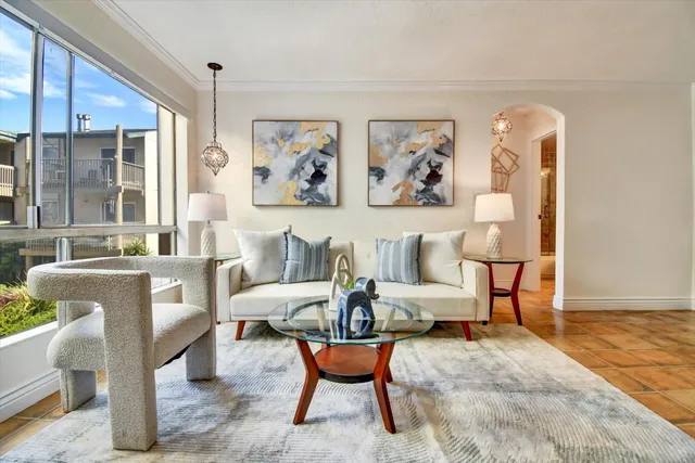 a living room with furniture and a large window