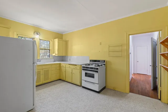 a kitchen with a refrigerator and a stove