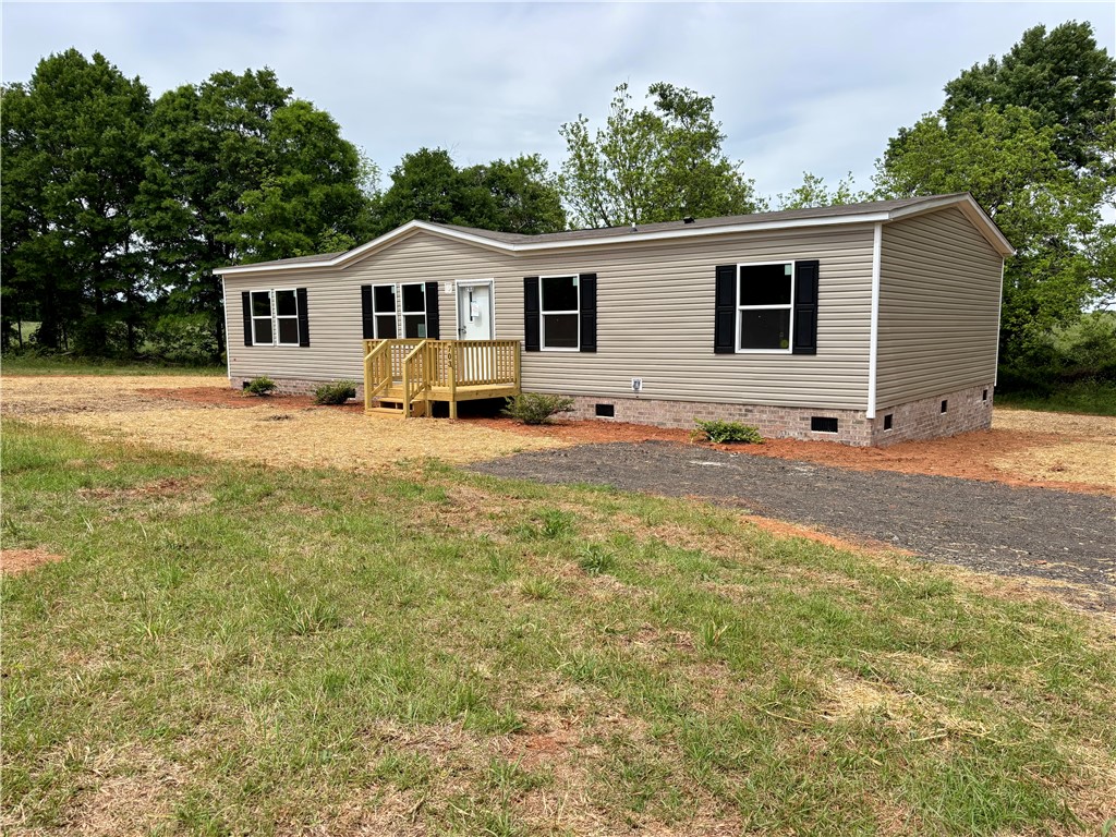703 Double Springs Road Townville, SC 29689 - Photo 20 of 22 This charming home offers comfortable living with a welcoming front porch and mature trees.