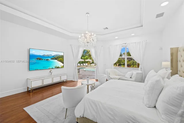 a bedroom with a bed and a chandelier