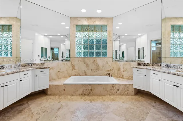 a bedroom with a bed and a desk next to a window